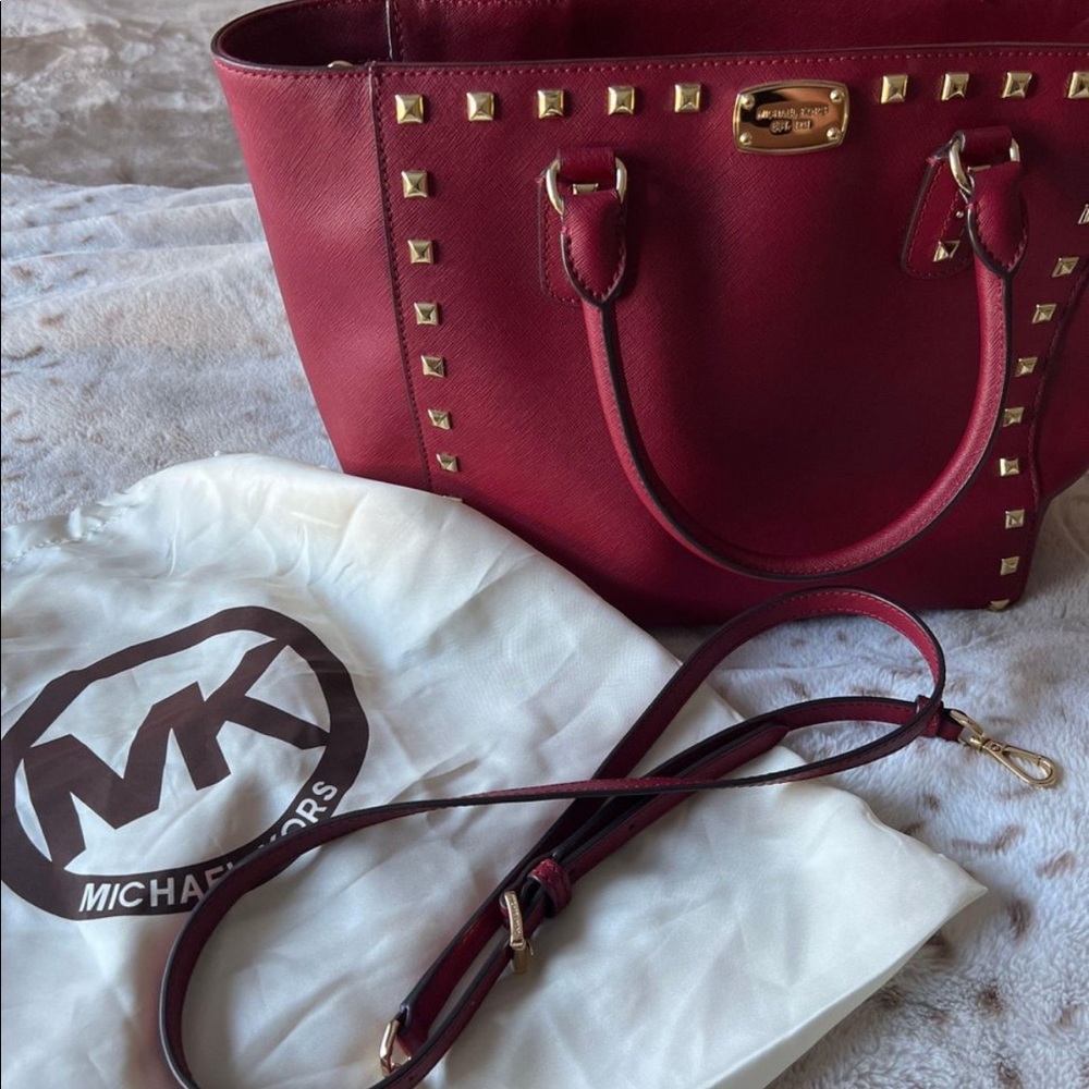Authentic MK tote, burgundy studded cokes with strap.